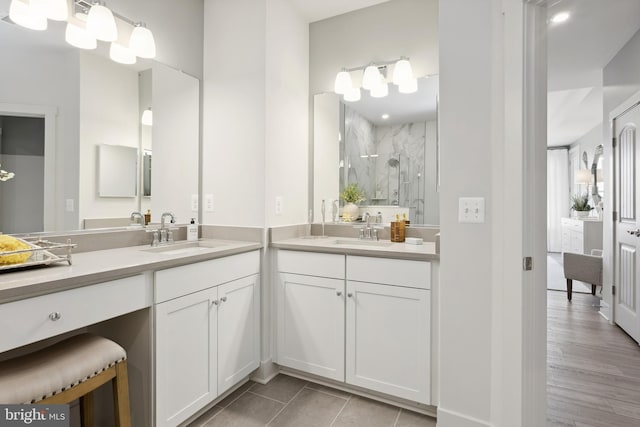 bathroom with hardwood / wood-style floors, vanity, and a shower with shower door