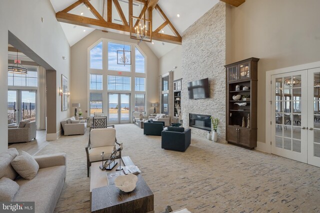 carpeted living room with high vaulted ceiling, an inviting chandelier, french doors, a fireplace, and beam ceiling