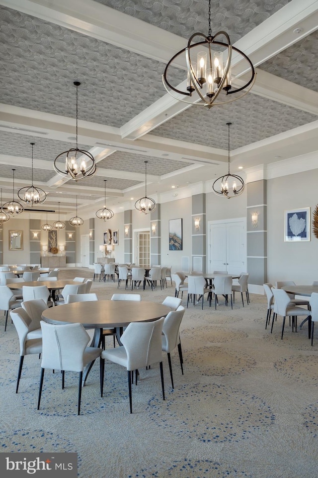 dining space featuring carpet, beam ceiling, and a towering ceiling