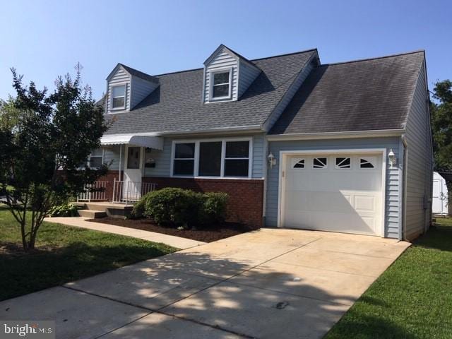 new england style home featuring a garage and a front yard