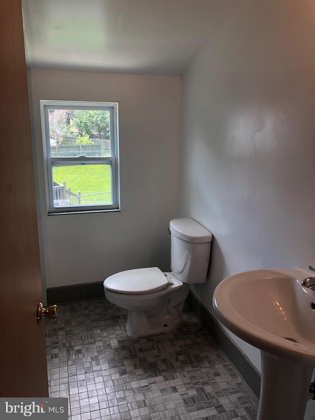 bathroom with tile patterned flooring and toilet