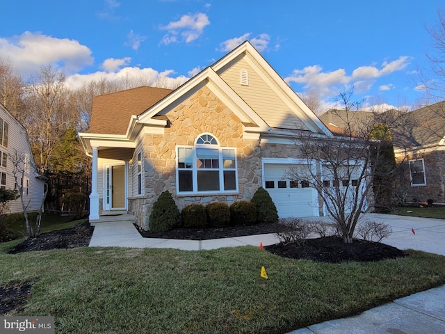 view of front of home with a front yard and a garage