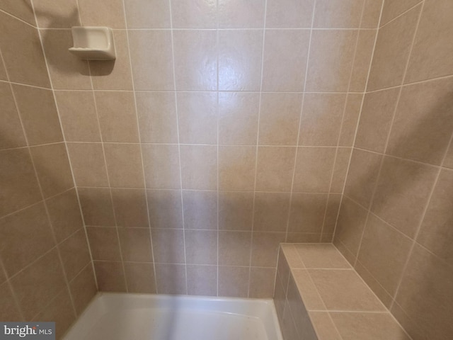 bathroom with a tile shower