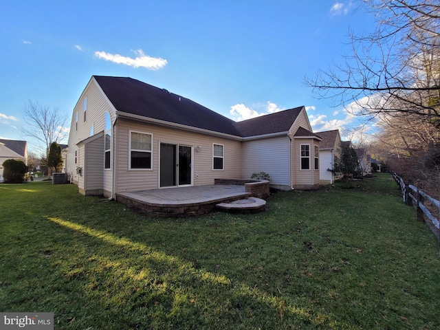 rear view of house with a lawn, a patio, and central AC