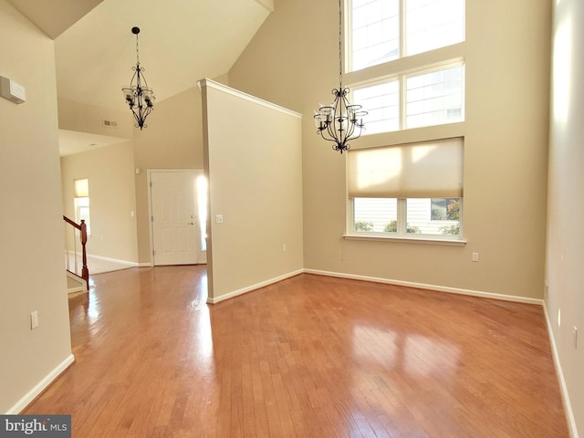 interior space featuring a chandelier, hardwood / wood-style flooring, and high vaulted ceiling