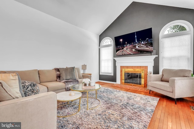 living room featuring a fireplace, wood-type flooring, and lofted ceiling