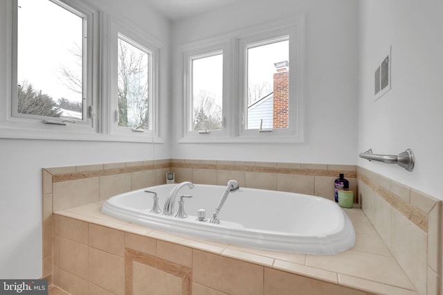 bathroom featuring tiled tub