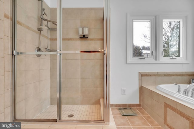 bathroom featuring tile patterned floors and independent shower and bath