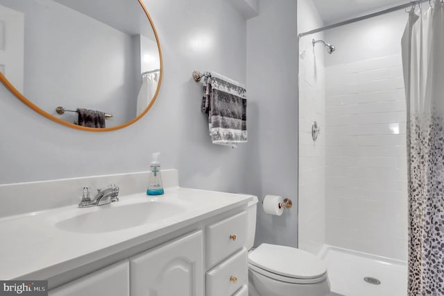 bathroom with walk in shower, vanity, and toilet