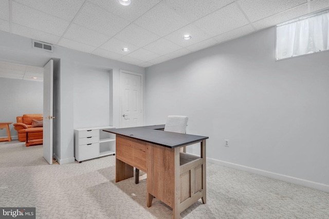 carpeted office with a drop ceiling