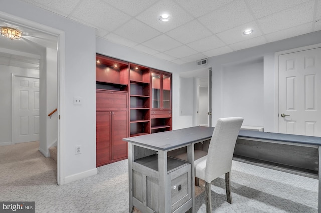 office area with a paneled ceiling and light colored carpet