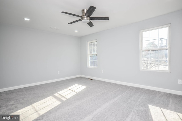 unfurnished room with ceiling fan and light colored carpet