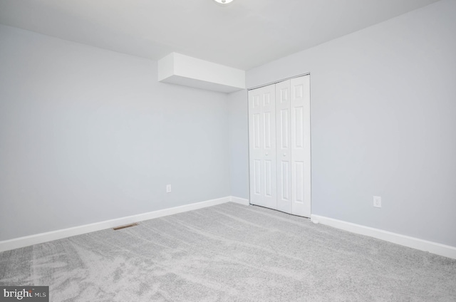 unfurnished bedroom with carpet floors and a closet