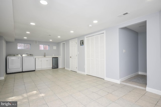 clothes washing area featuring washer and dryer and sink