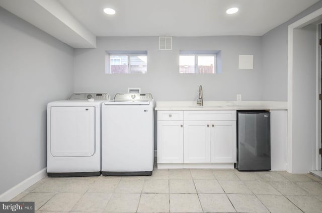 laundry room with separate washer and dryer and sink