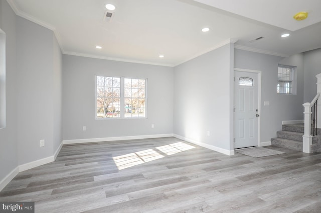 entryway featuring light hardwood / wood-style floors and crown molding