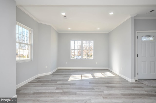 entryway featuring light wood-type flooring and ornamental molding