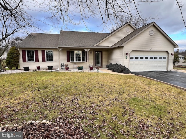 single story home featuring a front yard and a garage