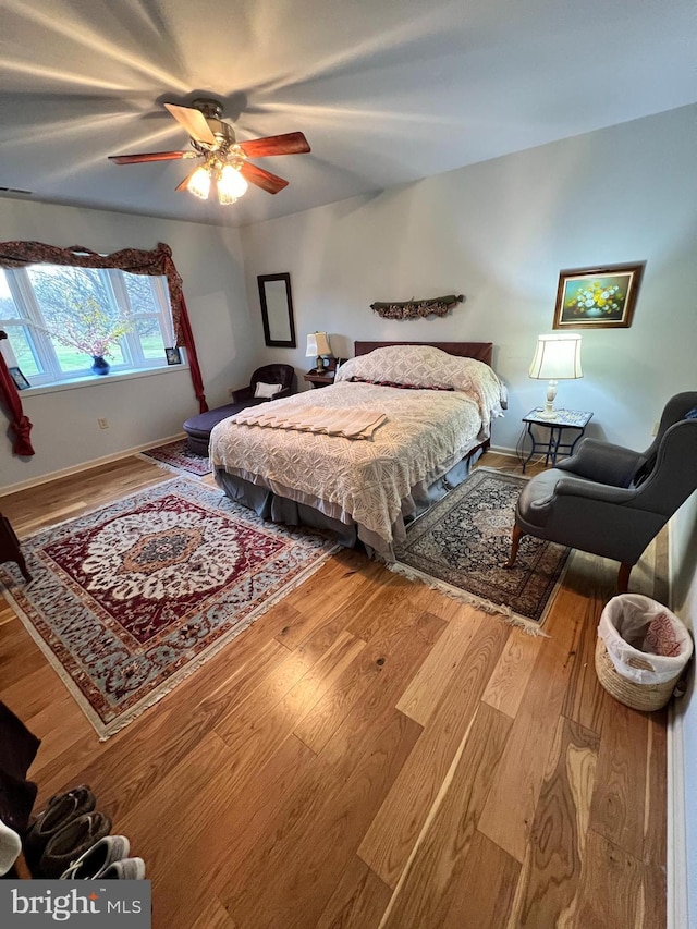 bedroom featuring hardwood / wood-style floors and ceiling fan