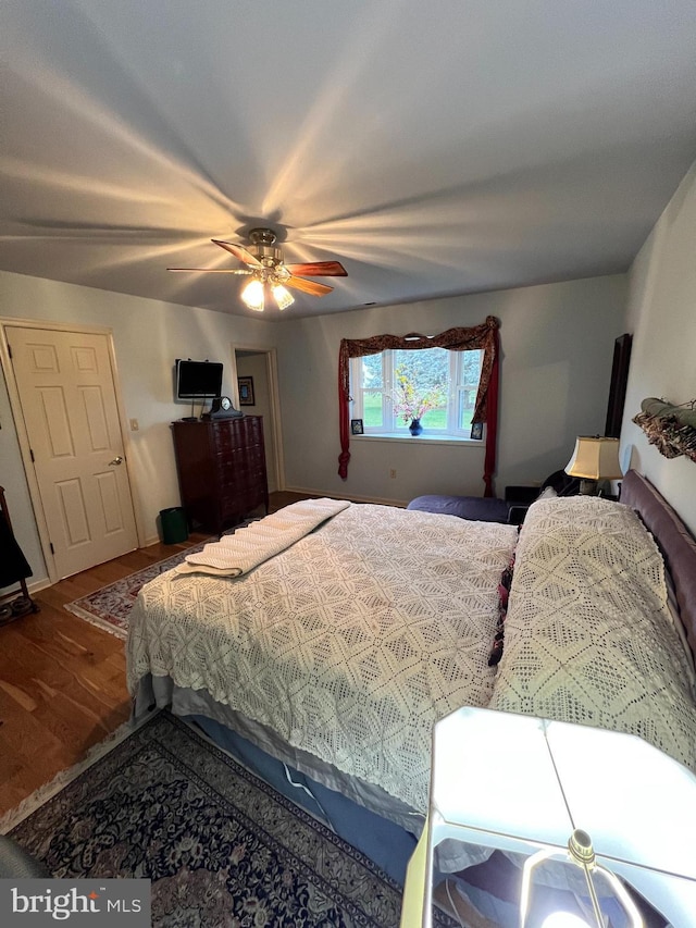 bedroom with ceiling fan and hardwood / wood-style floors