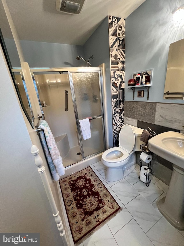 bathroom featuring toilet and walk in shower