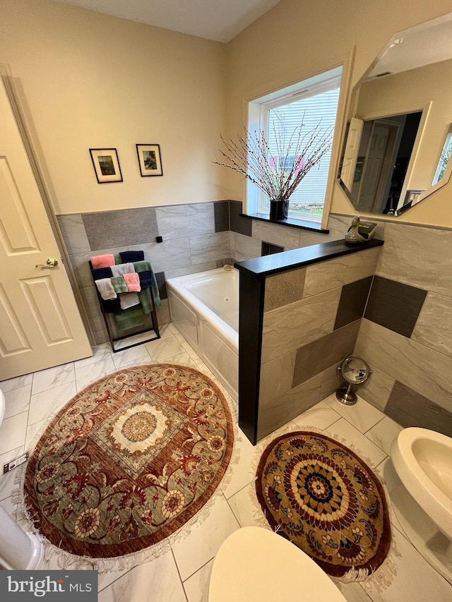 bathroom featuring toilet and tiled bath