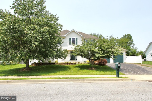931 Boxwood Dr, Smyrna, DE 19977 - obstructed view of property featuring driveway, a front yard, and an attached garage