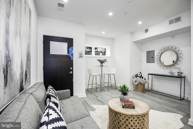 living room with electric panel and light wood-type flooring