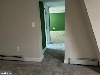 hall featuring carpet flooring and a baseboard heating unit