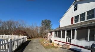 view of property exterior with a sunroom