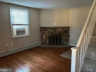 unfurnished living room with a fireplace, dark hardwood / wood-style floors, and a baseboard heating unit