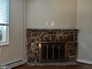 interior details with a fireplace and a baseboard radiator