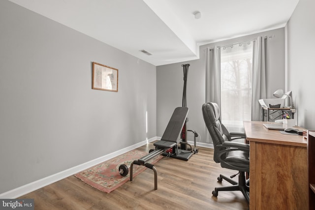 home office with light hardwood / wood-style floors