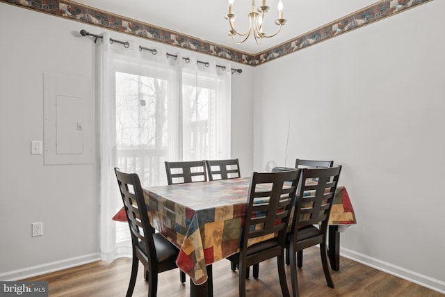 dining space with dark hardwood / wood-style flooring, electric panel, and a chandelier