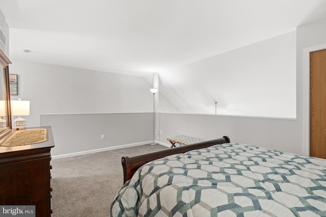 bedroom with carpet floors and vaulted ceiling