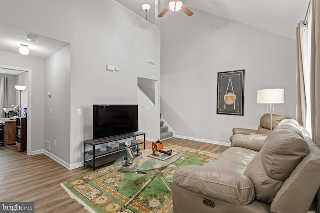 living room featuring ceiling fan, wood-type flooring, and high vaulted ceiling