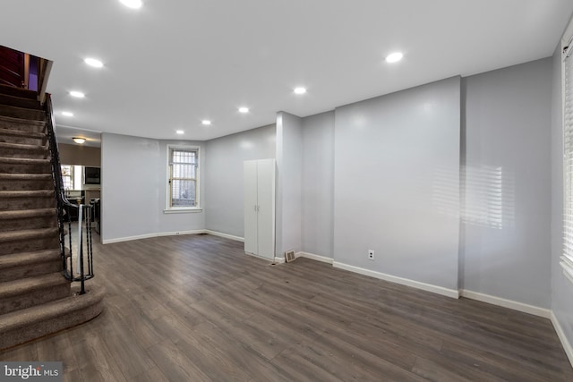 unfurnished living room featuring dark wood-type flooring