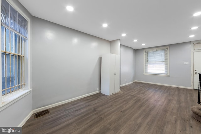 empty room with dark hardwood / wood-style flooring