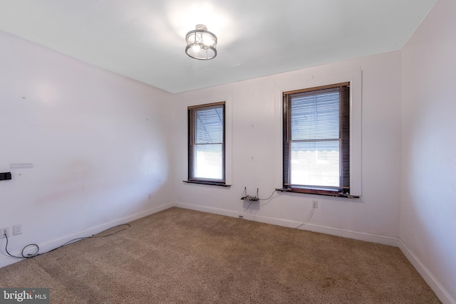 carpeted empty room featuring plenty of natural light