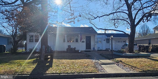 view of front of house featuring a front yard and a garage