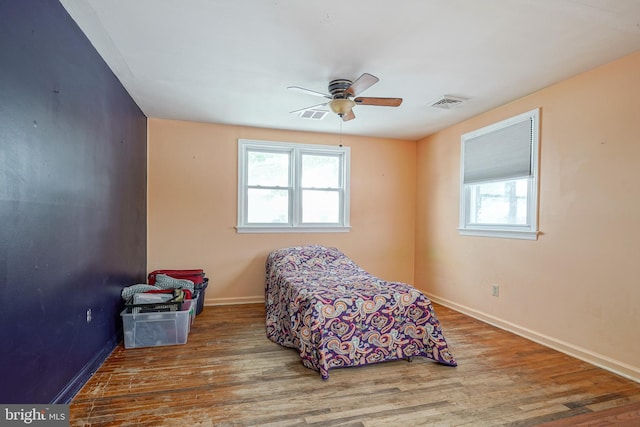 bedroom with wood-type flooring and ceiling fan