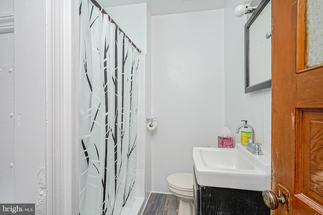 bathroom featuring hardwood / wood-style flooring, vanity, toilet, and a shower with shower curtain