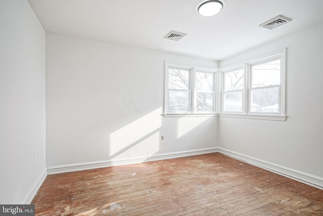 empty room with hardwood / wood-style flooring