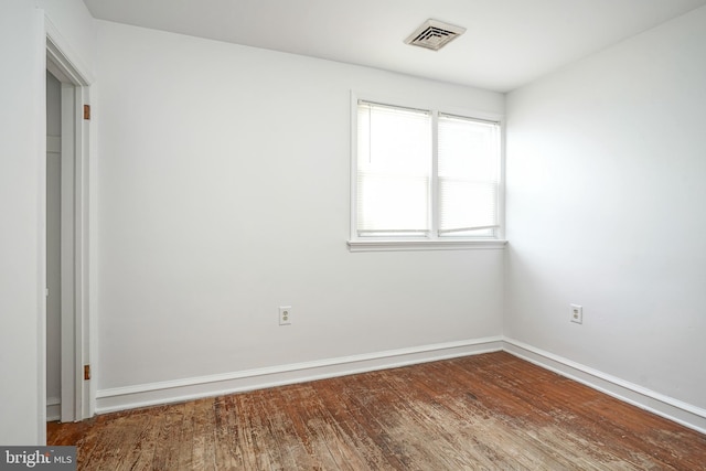 spare room featuring wood-type flooring