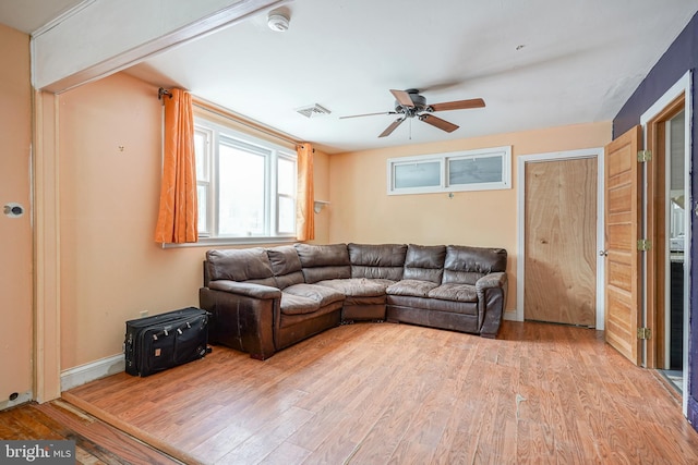 living room featuring ceiling fan and light wood-type flooring