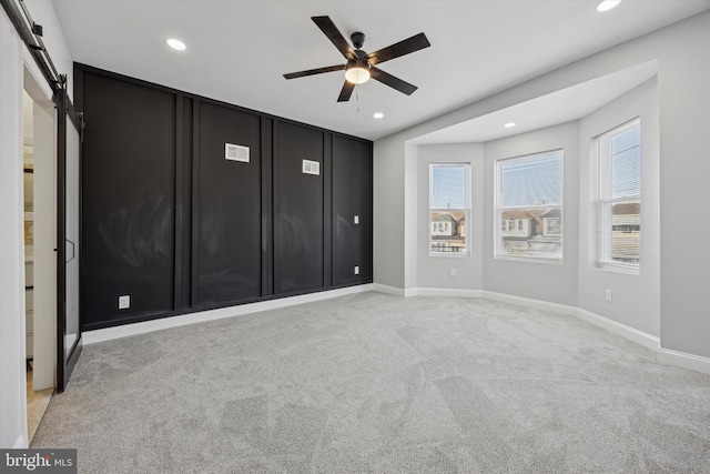 unfurnished bedroom with ceiling fan and light colored carpet