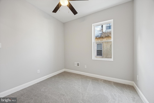 spare room with carpet flooring and ceiling fan