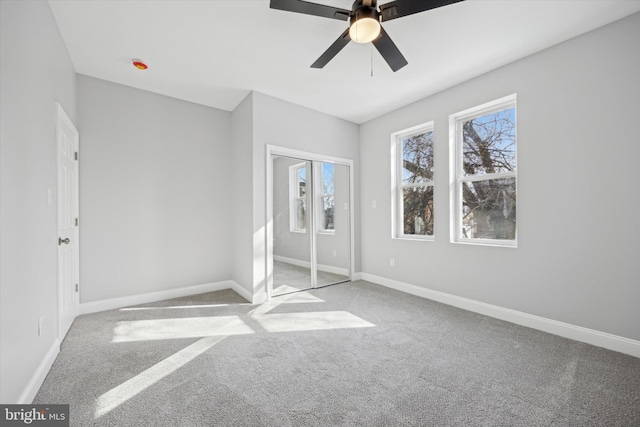 carpeted spare room with ceiling fan