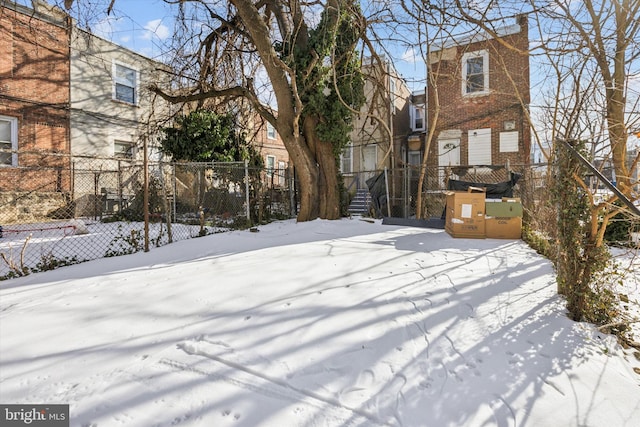 view of yard layered in snow