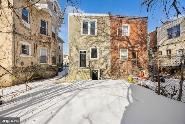 view of snow covered rear of property